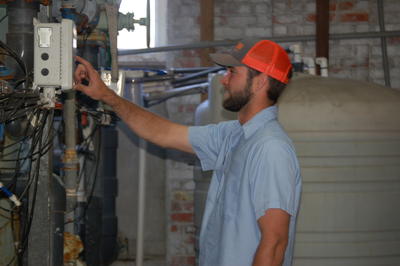 Public Utilities employee checks the water levels